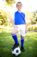 Front view of girl wearing soccer uniform standing
